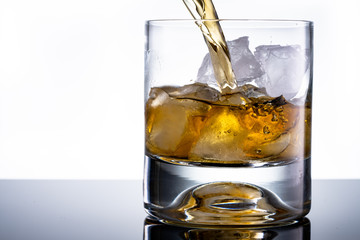 Glass of whiskey with ice cubes