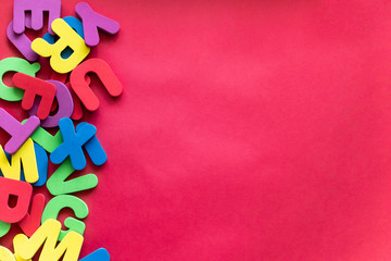 Letters of The Alphabet in Different Colors on a Red Background. Alphabet Study, ABC, Education Concept