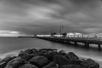 Grayscale photo of wooden dock  on body of water. - Powered by Adobe