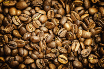 Roasted coffee beans background with dark edges. 