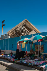 Collapsed Building with street seller as foreground
