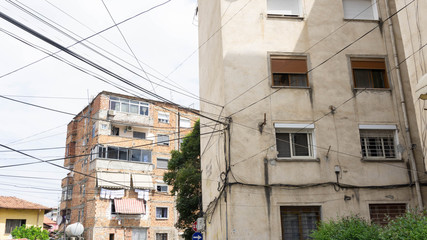Tirana, Albania – June 7, 2019: The ruin of the old Albanian building and its scattered electricity lines are in the city center of Tirana.