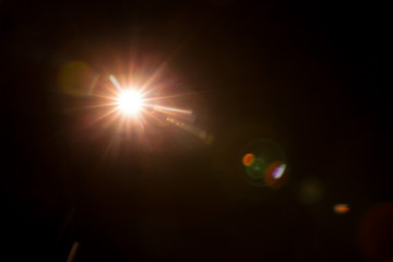 Abstract Natural Sun flare on the black background.