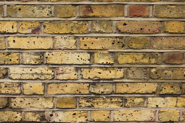 Yellow brick wall. Background and texture. Construction concept. Landscape format.
