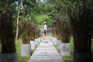 Fototapeta na wymiar Woman walking in the garden at Rayong, Thailand