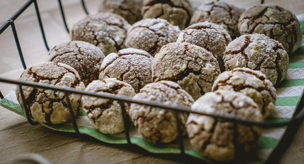 Fototapeta na wymiar Chocolate crinkle cookies in a basket on wooden table. Top view. Landscape format.