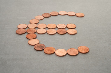 euro currency sign made from coins on concrete background