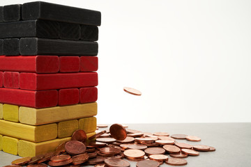 euro coins falling on colored bricks symbolisign the german flag