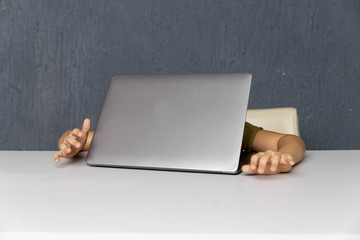 Upset boy sitting and studying on the computer online at quarantine time