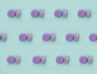 Obraz na płótnie Canvas Colorful macarons dessert on blue background.