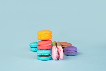Colorful macarons dessert on blue background.