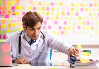 Male doctor with many conflicting prioritites