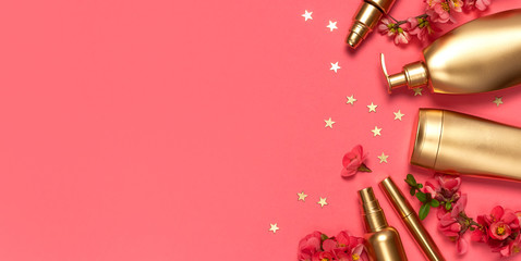 Cosmetics Branding Concept. Cosmetics, spring pink flowers, gold stars confetti on pink background....