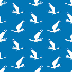 Seamless pattern of silhouettes flying birds in the sky