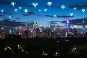 Naklejka premium Wireless communication network in Big city in Asia concept. Abstract wifi icons on Kuala lumpur city landmark background