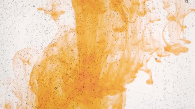 flat bottle and orange ink solution in water