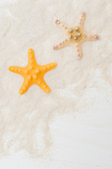 Fototapeta na wymiar Flat lay composition with color starfish and sand