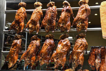 Roasted ducks hanging on rack showcase
