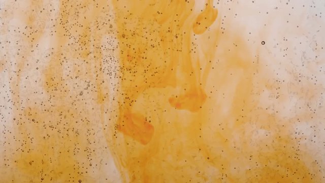 flat bottle and  orange ink solution in water