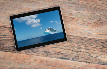 Cruise ship on digital tablet screen. Cruise travel and travel agency sales concept.