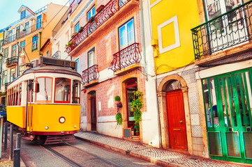 Yellow vintage tram on the street in Lisbon, Portugal. Famous travel destination - obrazy, fototapety, plakaty