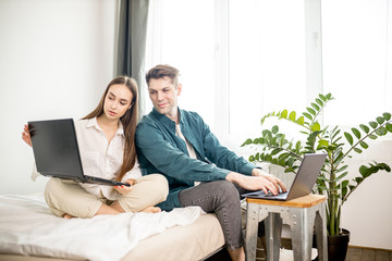 young caucasian married couple looking for a bargain online, they use their own laptop, want to do...