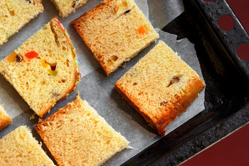 closeup photo of slices of traditional dried fruits cake for christmas ready for baking on the baking sheet