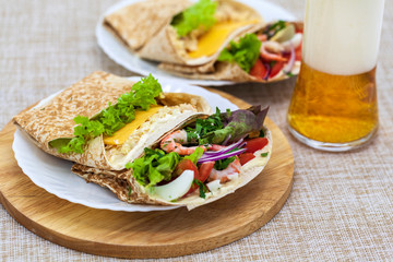 tortillas in envelopes, stuffed with shrimp and vegetables, parmesan and tuna fillet meat, beer snack
