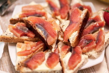Cold appetizers, sandwiches with butter and red fish