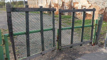wooden gate closed with metal locker