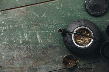 Tea composition flat lay, Teapot with dry tea leaves, Making tea