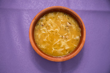 purple backgrounds . Erishde dish, eggplant stuffed dish and cucumber, tomato salad . Kesme, egg noodle , Kyrgyz, Azerbaijan cuisine, Traditional assorted dishes, Top view.