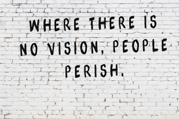 Black painted inscription of smart quote on white brick wall © iushakovsky