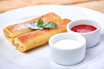 pancakes with sour cream and berry sauce
