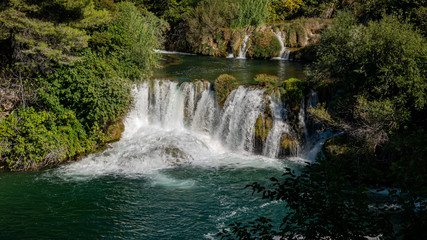 Fototapeta na wymiar Amazing view of the natural Krka waterfalls. Sunny day, view of the Krka National Park located by Roski Slap in Croatia.