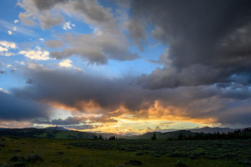 Naklejka na ściany i meble Sunset Highlights Low Clouds in Storm Over Yellowstone