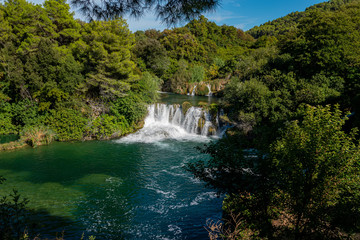 Fototapeta na wymiar Amazing view of the natural Krka waterfalls. Sunny day, view of the Krka National Park located by Roski Slap in Croatia.