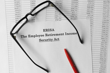Paper with Employee Retirement Income Security Act ERISA on a table.