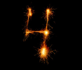number four written with a sparkler on a black background