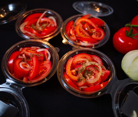Ripe tomatoes on dark wooden background