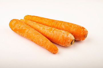 a few ripe carrots on a white background. Close up.
