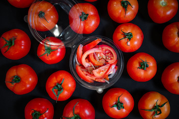 Ripe tomatoes on dark wooden background