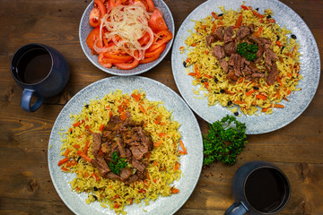 Samarkand pilaf. lamb,rice,onion,yellow carrots,vegetable oil,spices. on the table in kicks not mixing.Uzbek national dish.The horizontal projection of the.