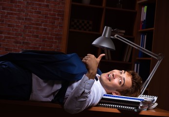 Young businessman working in the office at night