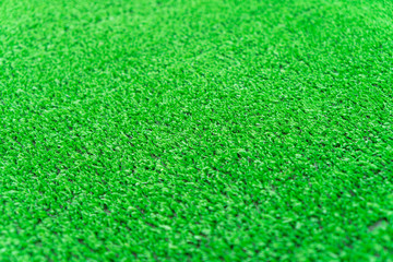 Fototapeta premium Artificial grass lawn texture. Artificial Turf Background. Greening with an artificial grass. Artificial turf laying background texture. Synthenic grass layer