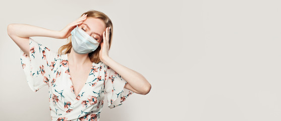 Stressed woman in medical face mask on white background