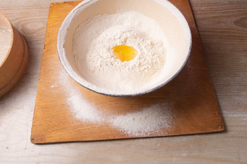 Female hands mixing dough in the home kitchen.