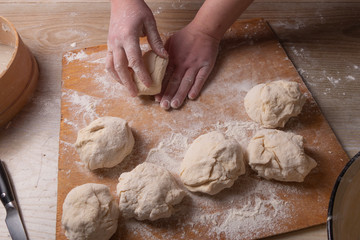 Female hands mixing dough in the home kitchen.