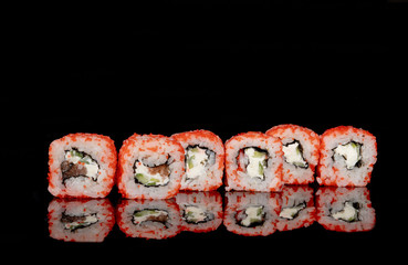 Philadelphia roll with salmon, cheese and cucumber on a black background with reflection. Sushi Philadelphia