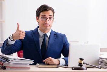 Young handsome judge working in court